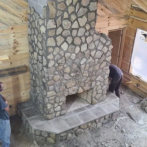 A fieldstone fireplace and hearth.